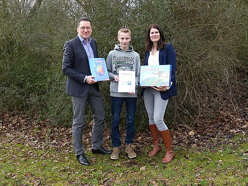 Schulleiter Robert Baberske und Erdkunde-Lehrerin Johanna Lameyer gratulieren Sven-Ole Gülke zu seinem Erfolg.